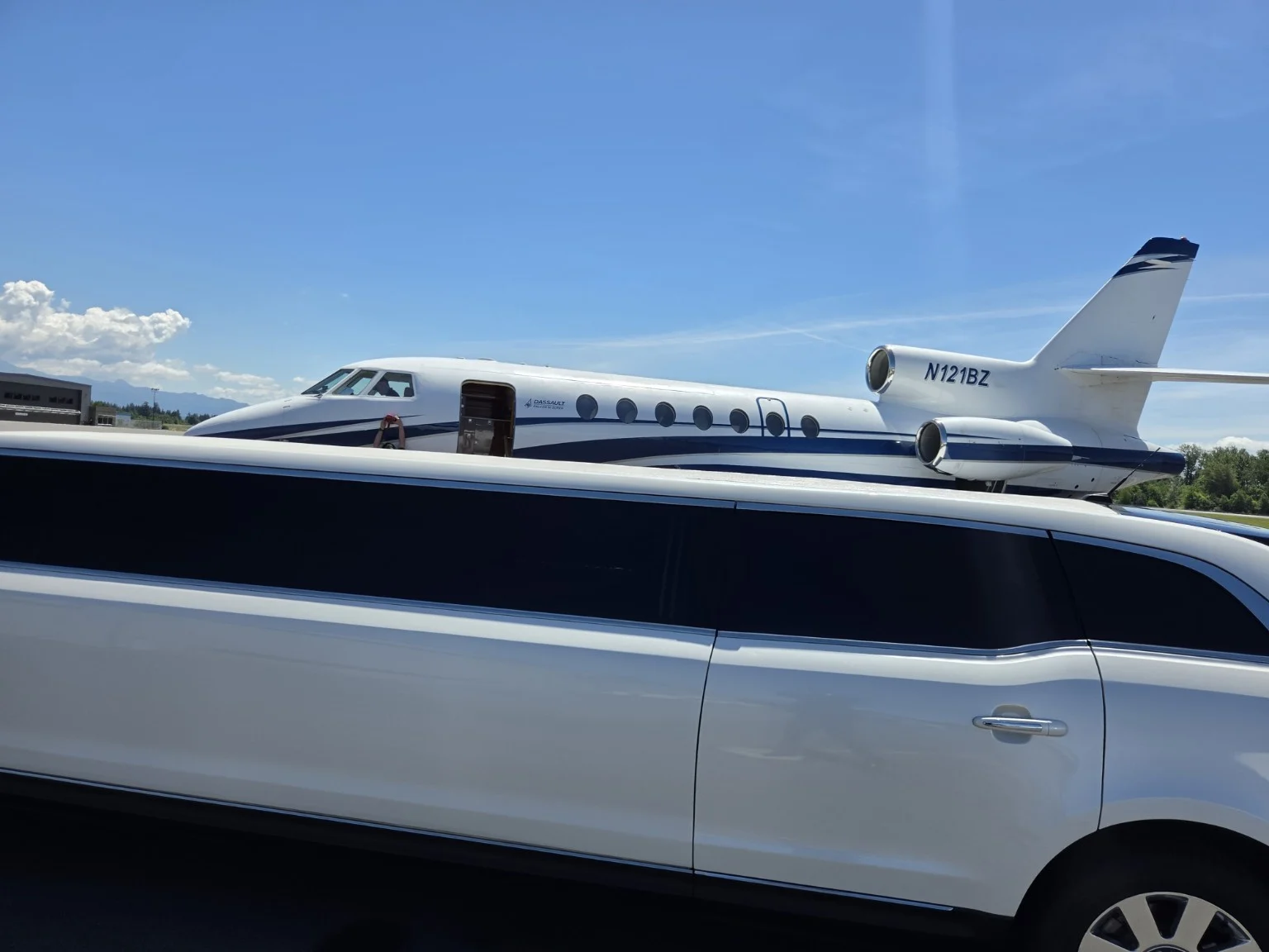 Whidbey Island stretch limousine at Skagit Regional Airport next to a private jet